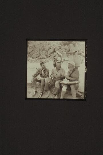 Briefing the course from Diamond Creek to the head of Lake Mead, Mile 235. Diamond Creek Camp. Left to right (seated): Hugh Cutler; Rod Sanderson; and Marston. Above are Buzzy Belknap and a portion of Masland