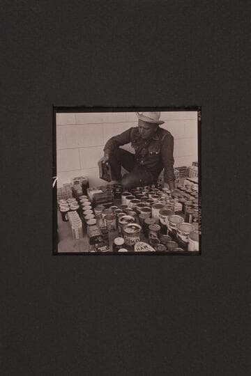 Bill Belknap checks the supplies at Boulder City before taking them to Lees Ferry and other points.  Outboard motor traverse of the Grand Canyon